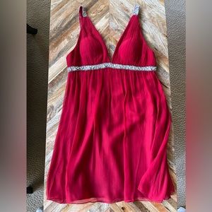 Sexy red baby doll length party dress with rhinestone detail.